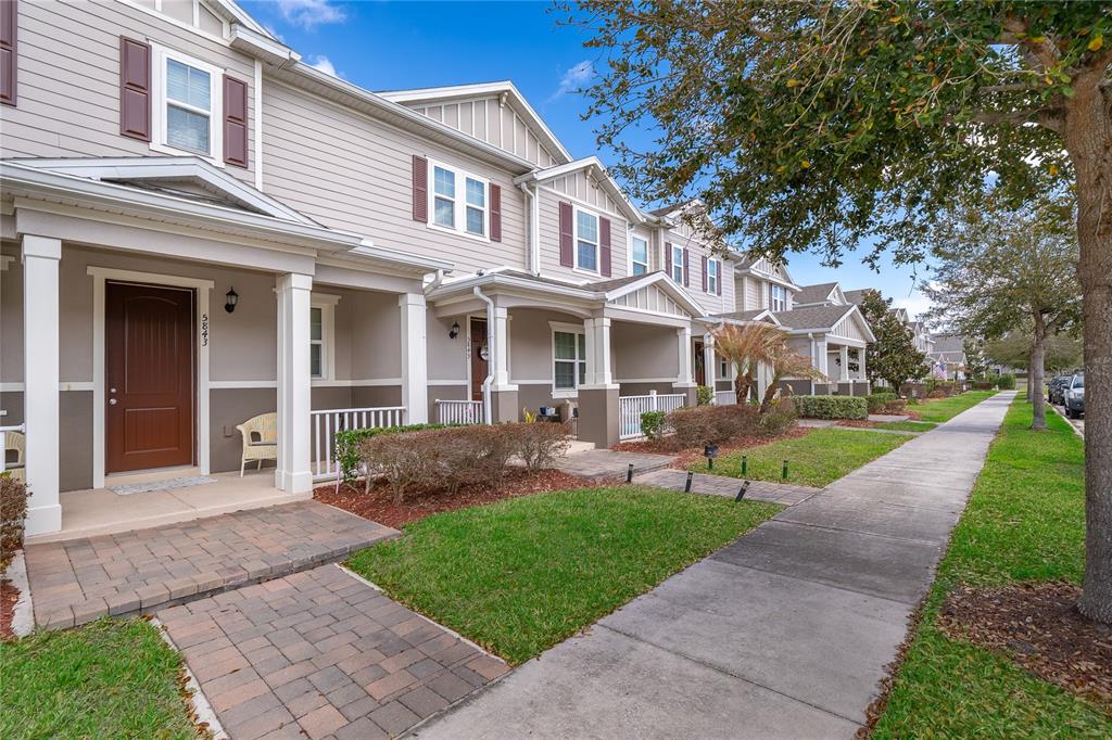 5849 Soter Lane Windermere, FL 34786 - Photo 20 of 31 a front view of a house with a yard and potted plants