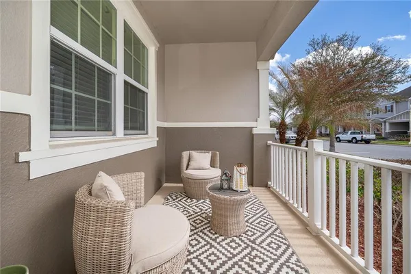 a view of a balcony with two chairs