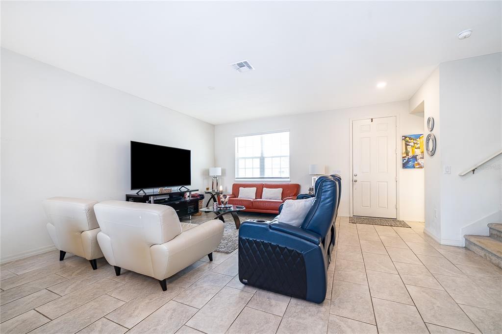 5849 Soter Lane Windermere, FL 34786 - Photo 8 of 31 a living room with furniture and a flat screen tv