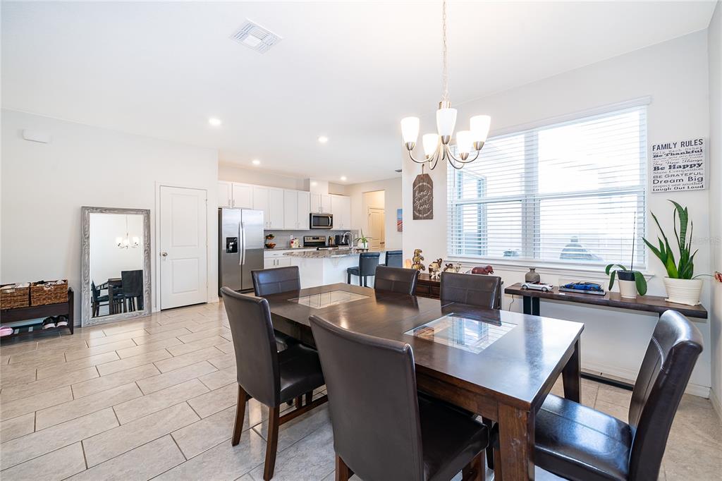 5849 Soter Lane Windermere, FL 34786 - Photo 9 of 31 a dining room with stainless steel appliances a table and chairs