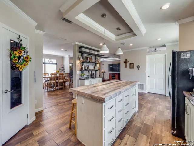 a kitchen with stainless steel appliances granite countertop a lot of counter space and a refrigerator
