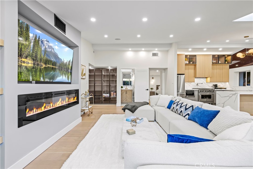 22263 Flanco Road Woodland Hills, CA 91364 - Photo 16 of 69 a living room with fireplace furniture and a flat screen tv