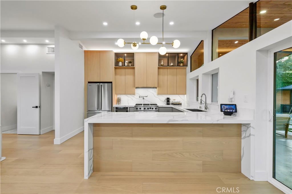 22263 Flanco Road Woodland Hills, CA 91364 - Photo 18 of 69 a large white kitchen with a large window