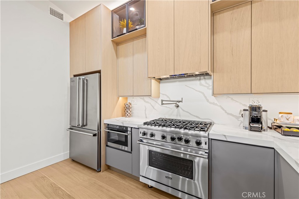 22263 Flanco Road Woodland Hills, CA 91364 - Photo 23 of 69 a kitchen with cabinets and steel stainless steel appliances