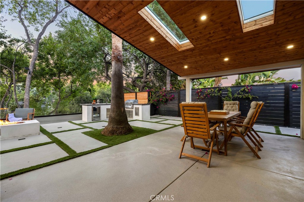 22263 Flanco Road Woodland Hills, CA 91364 - Photo 30 of 69 a view of a patio with a table and chairs
