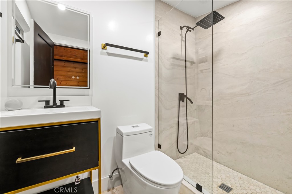 22263 Flanco Road Woodland Hills, CA 91364 - Photo 41 of 69 a bathroom with a toilet sink shower and mirror