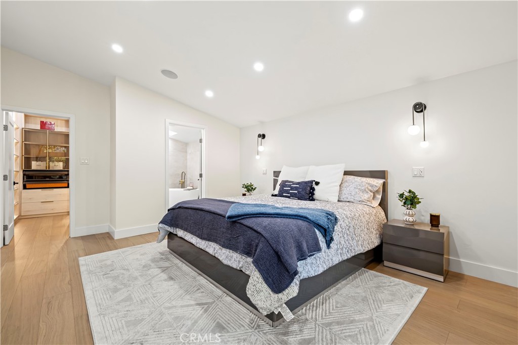 22263 Flanco Road Woodland Hills, CA 91364 - Photo 45 of 69 a spacious bedroom with a bed and wooden floor