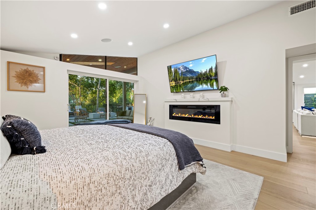 22263 Flanco Road Woodland Hills, CA 91364 - Photo 46 of 69 a bedroom with a bed and a painting on the wall