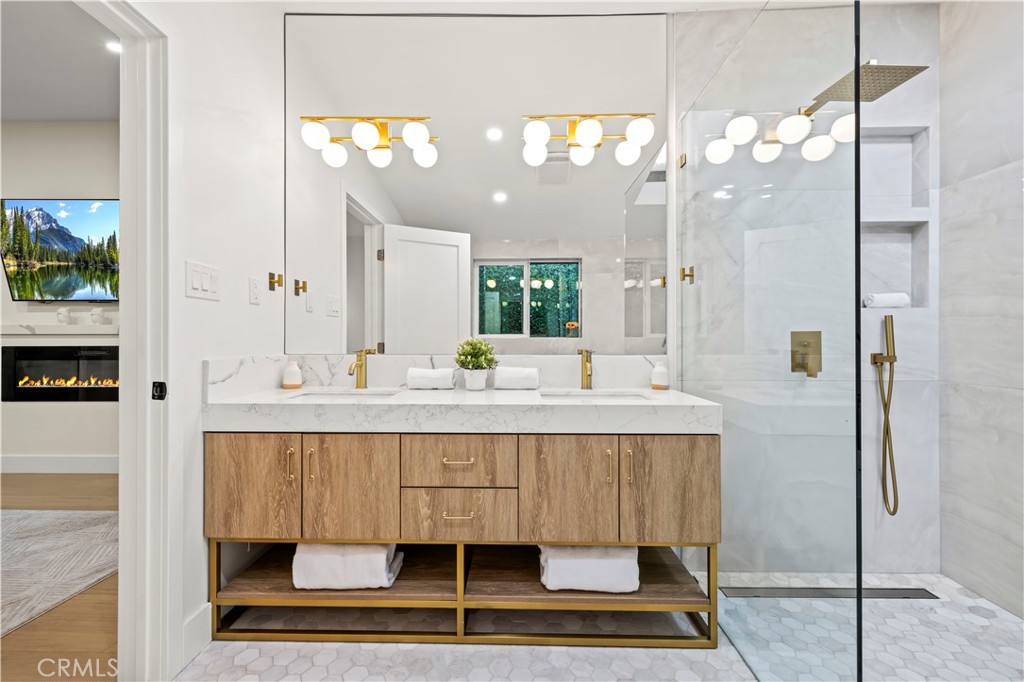 22263 Flanco Road Woodland Hills, CA 91364 - Photo 47 of 69 a bathroom with a sink a mirror and a shower