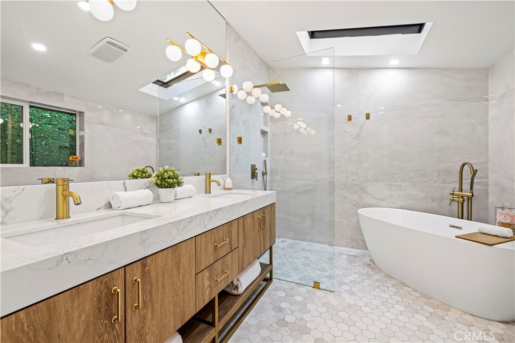 22263 Flanco Road Woodland Hills, CA 91364 - Photo 48 of 69 a bathroom with double vanity sinks a vanity a lamp and a shower