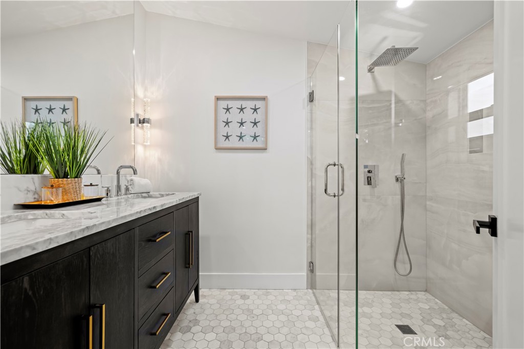 22263 Flanco Road Woodland Hills, CA 91364 - Photo 9 of 69 a bathroom with a granite countertop sink a mirror and shower