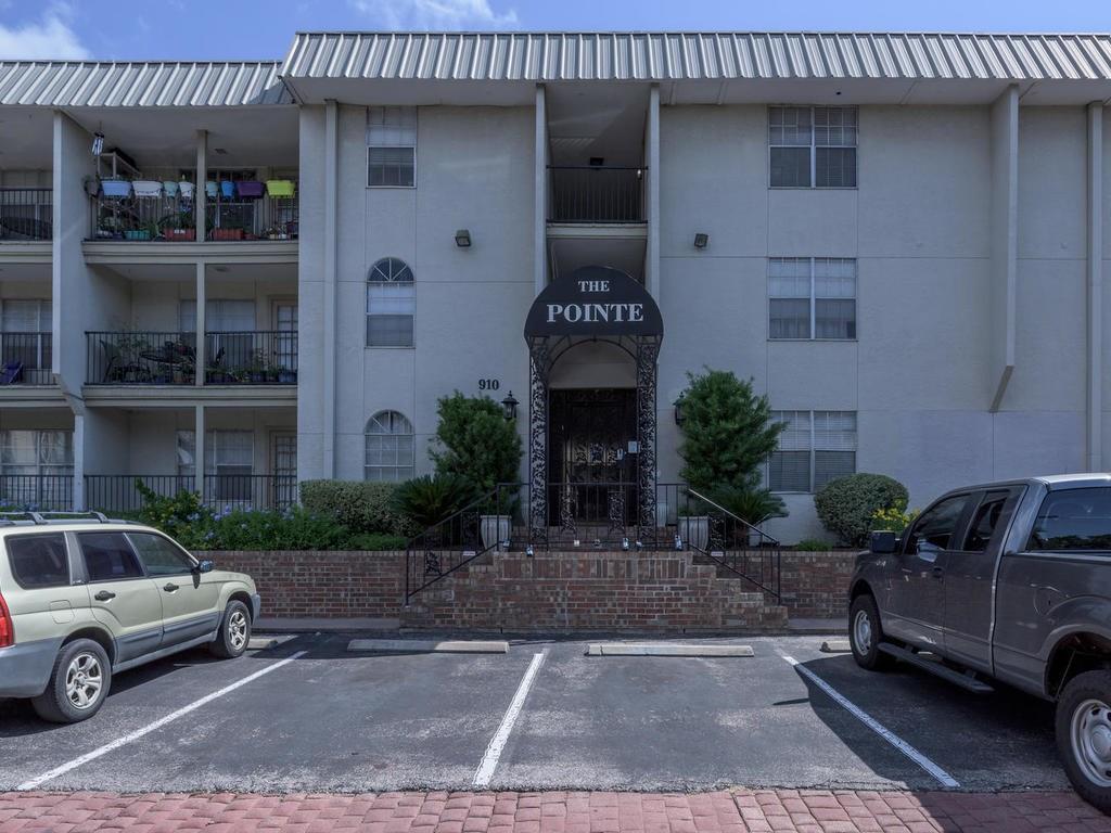910 Duncan Lane, Unit 2 Austin, TX 78705 - Photo 7 of 11 Secure building with inviting balconies, a brick foundation, and ample parking.