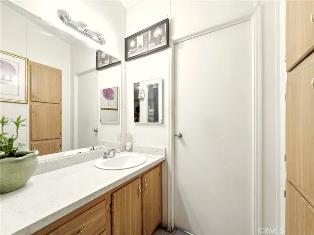 a bathroom with a sink vanity granite and a mirror