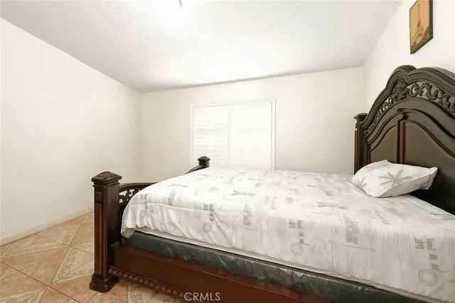 a bedroom with a bed and dresser