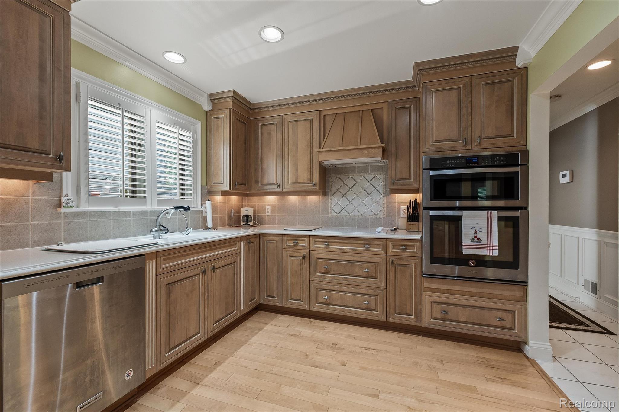 1662 Sumac Drive Rochester, MI 48309 - Photo 14 of 38 Kitchen featuring wood cabinetry, stainless steel appliances, light wood-finish flooring, recessed lighting, and a white countertop