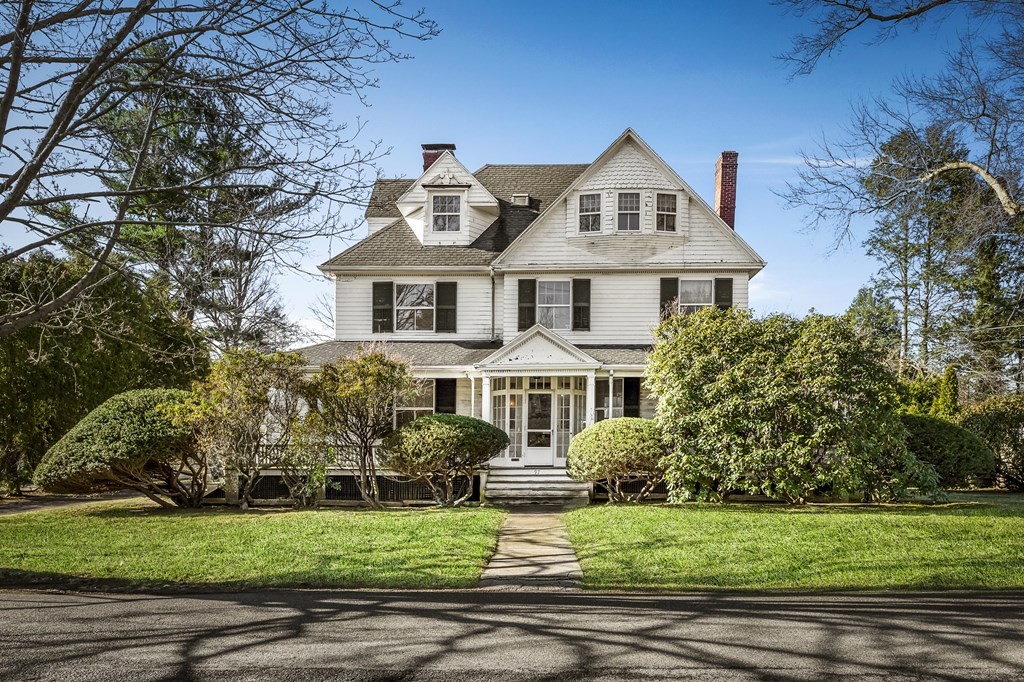 a front view of a house with a garden