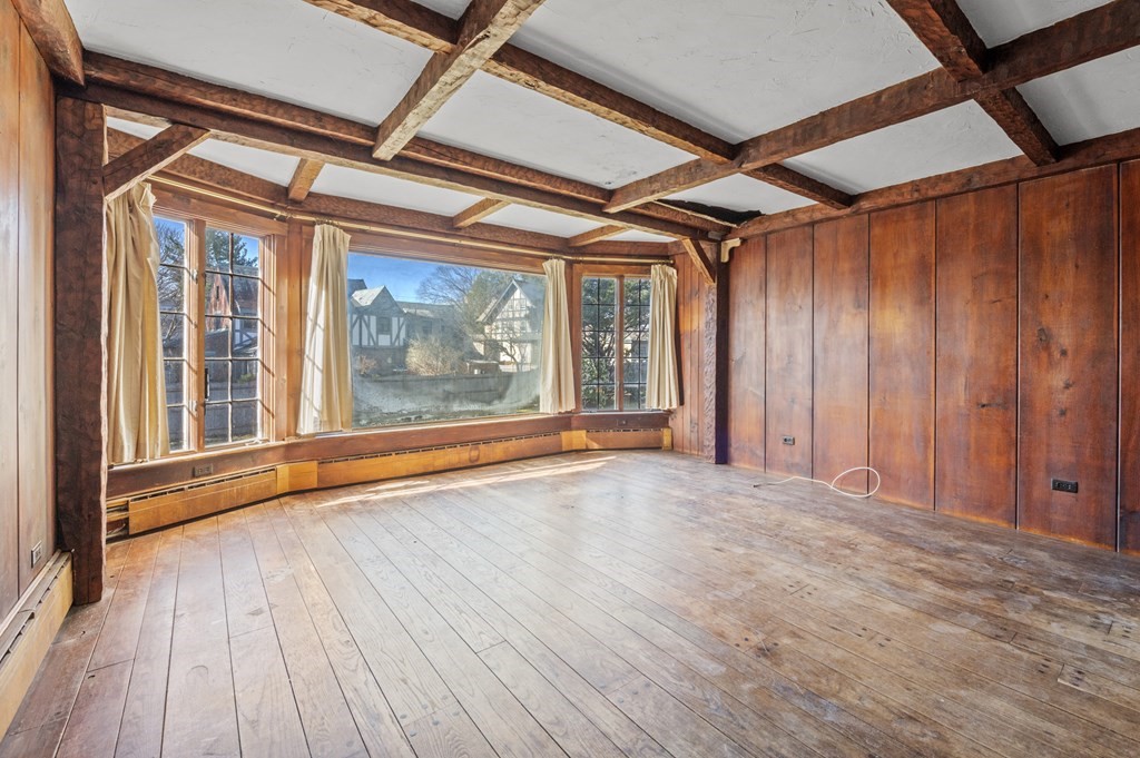 97 Beach Bluff Avenue Swampscott, MA 01907 - Photo 15 of 36 an empty room with wooden floor and door