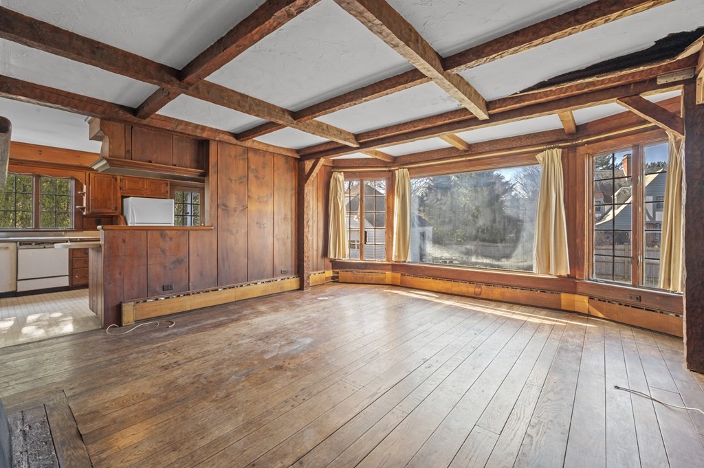 97 Beach Bluff Avenue Swampscott, MA 01907 - Photo 16 of 36 a view of an empty room with wooden floor and a window