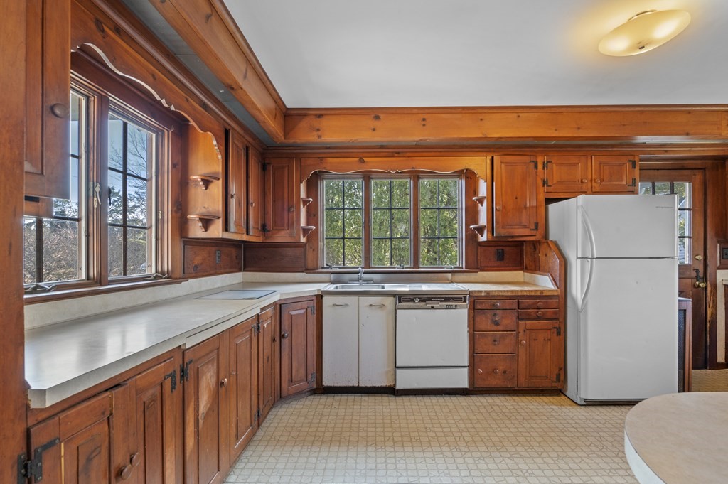 97 Beach Bluff Avenue Swampscott, MA 01907 - Photo 18 of 36 a kitchen with stainless steel appliances granite countertop a refrigerator and a sink