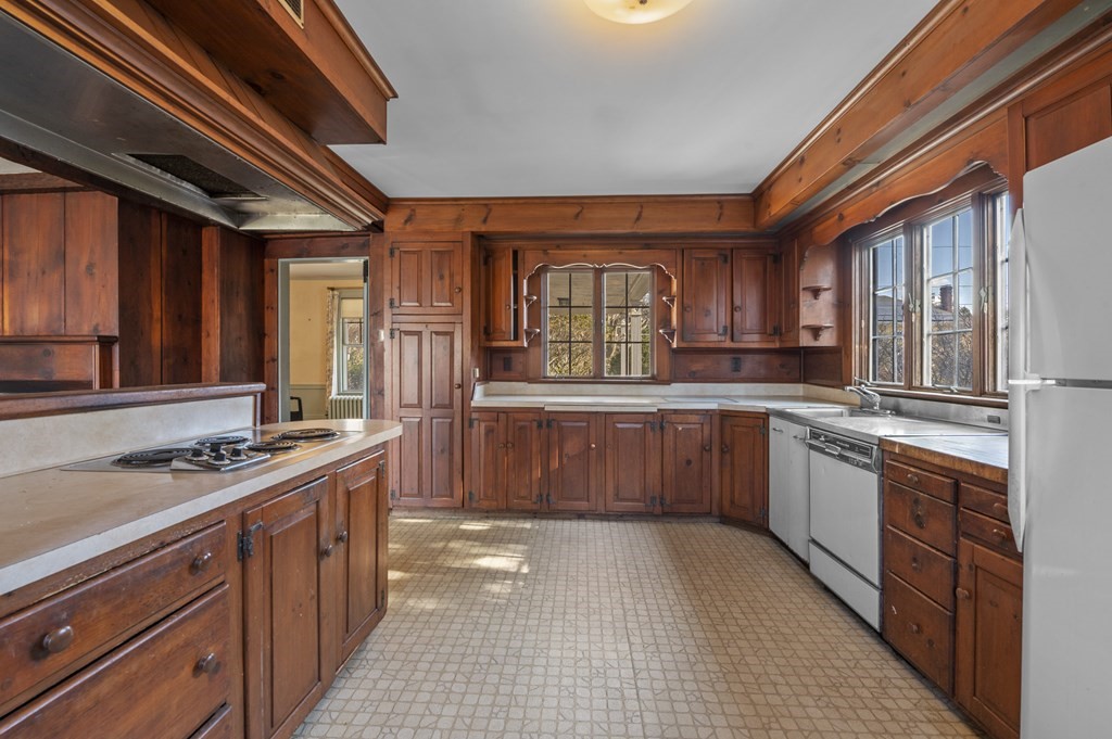 97 Beach Bluff Avenue Swampscott, MA 01907 - Photo 19 of 36 a kitchen with stainless steel appliances granite countertop a stove a sink dishwasher and a refrigerator