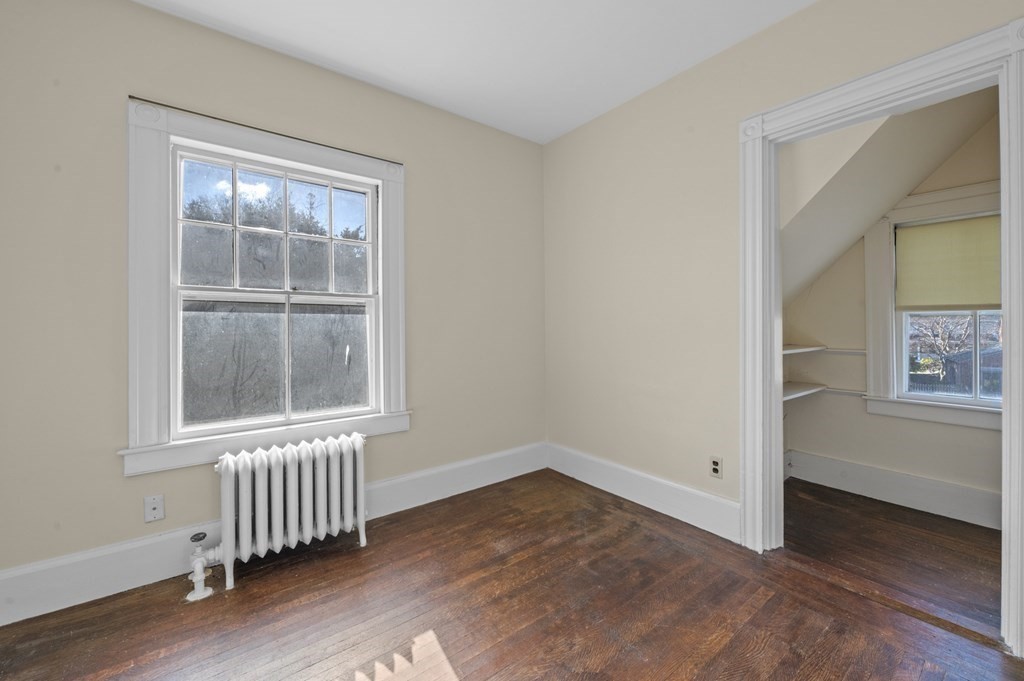97 Beach Bluff Avenue Swampscott, MA 01907 - Photo 25 of 36 an empty room with wooden floor and windows