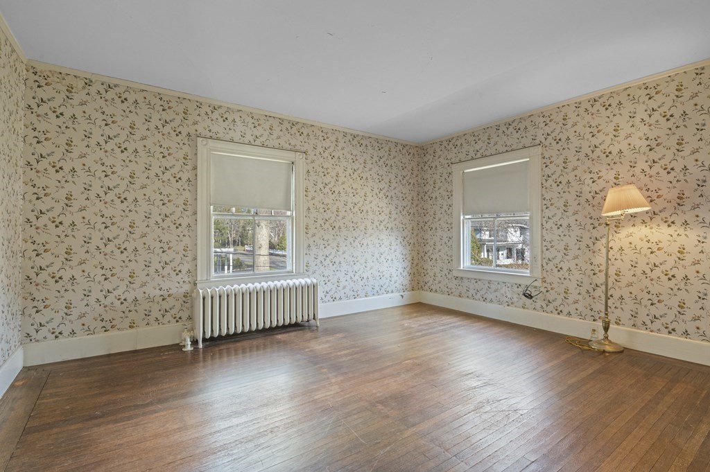 97 Beach Bluff Avenue Swampscott, MA 01907 - Photo 29 of 36 an empty room with wooden floor and windows
