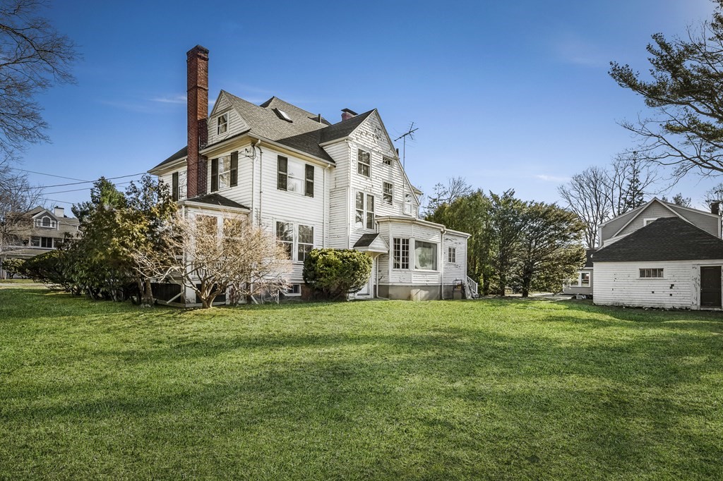 97 Beach Bluff Avenue Swampscott, MA 01907 - Photo 7 of 36 a front view of a house with a yard