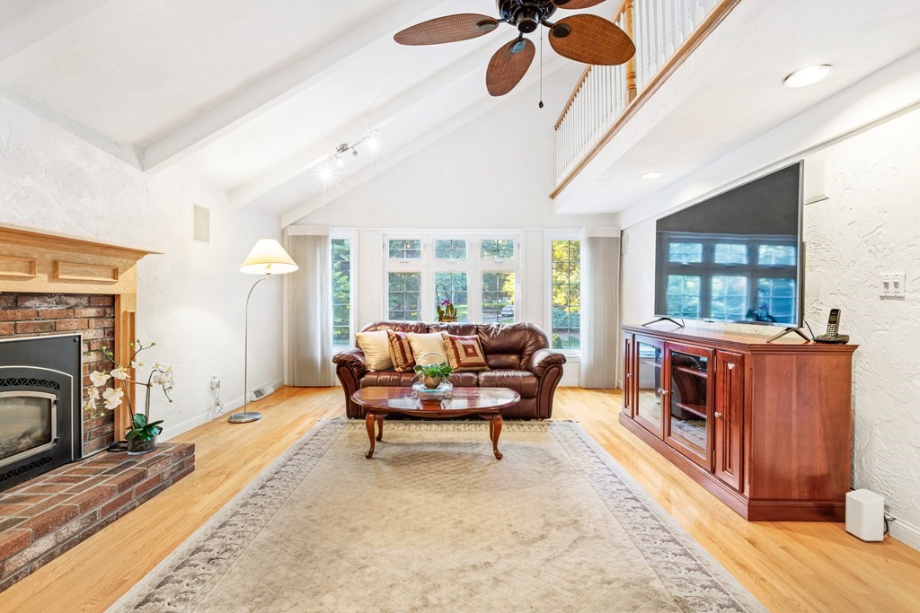 27 Lewis Road Foxboro, MA 02035 - Photo 8 of 40 a living room with furniture and a fireplace