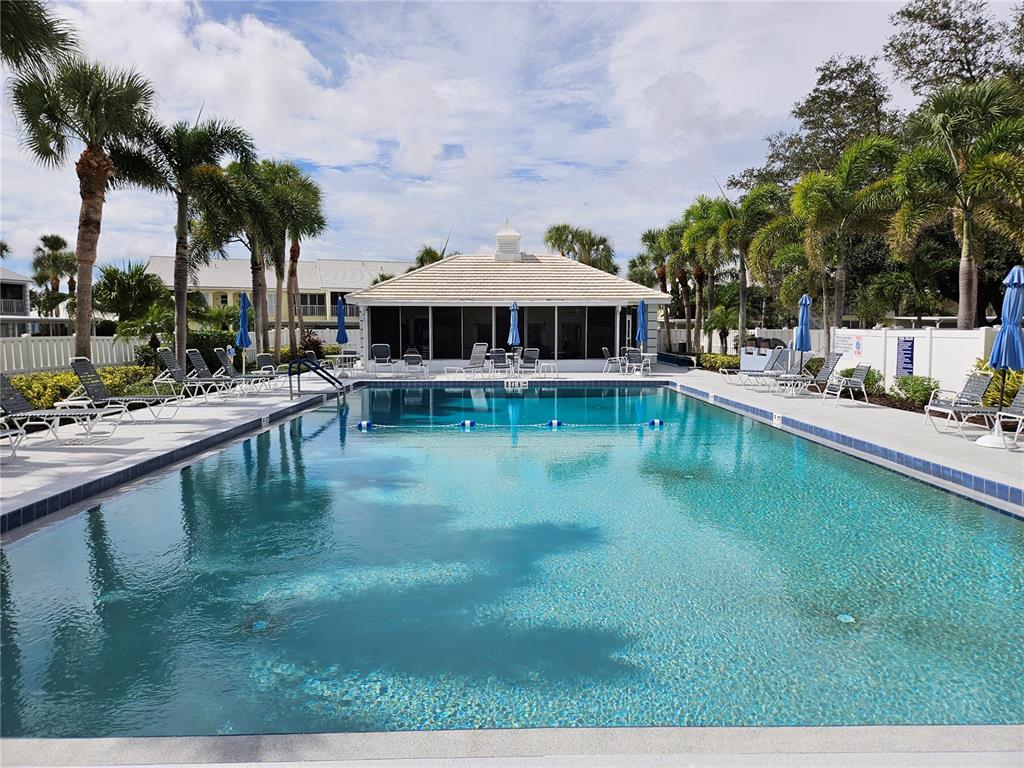 435 Cerromar Lane, Unit 329 Venice, FL 34293 - Photo 2 of 59 a view of a swimming pool with a patio