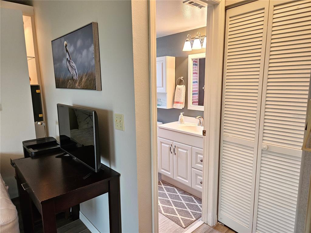 435 Cerromar Lane, Unit 329 Venice, FL 34293 - Photo 21 of 59 a bathroom with a sink a mirror and a window