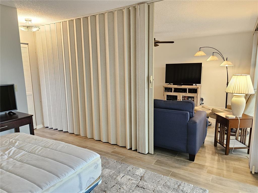 435 Cerromar Lane, Unit 329 Venice, FL 34293 - Photo 28 of 59 a bedroom with a bed and a flat screen tv