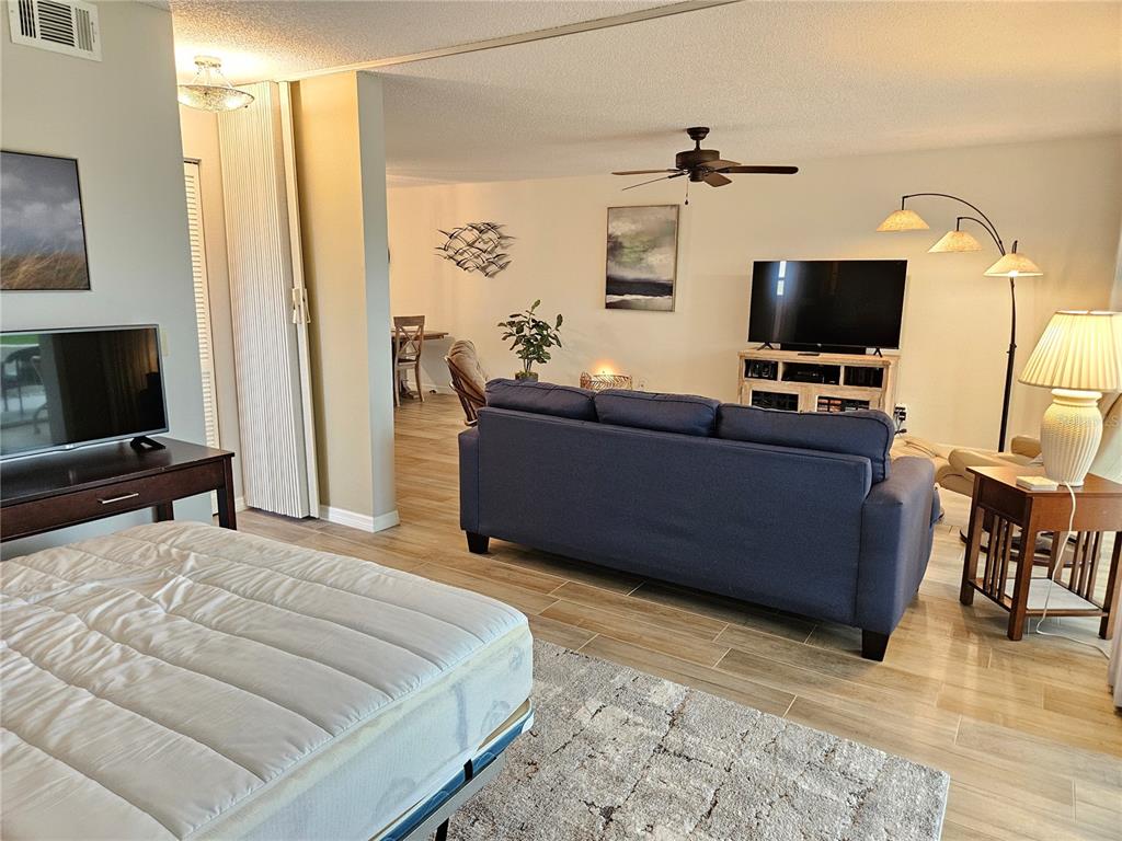 435 Cerromar Lane, Unit 329 Venice, FL 34293 - Photo 31 of 59 a bedroom with a bed and flat screen tv