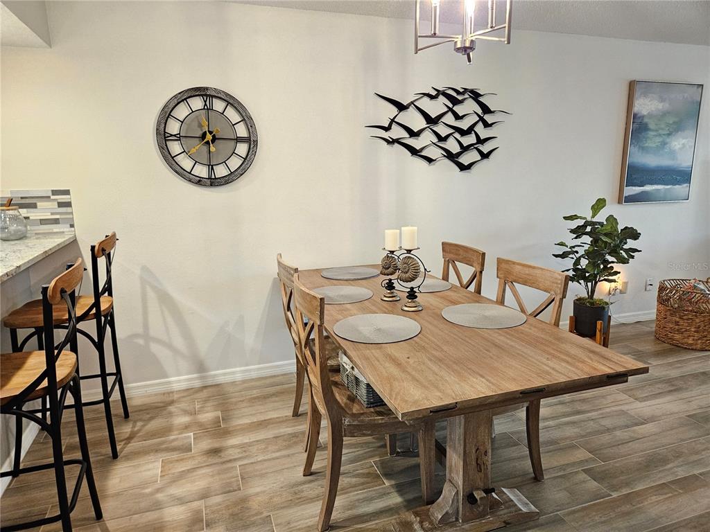 435 Cerromar Lane, Unit 329 Venice, FL 34293 - Photo 35 of 59 a view of a dining room with furniture and wooden floor