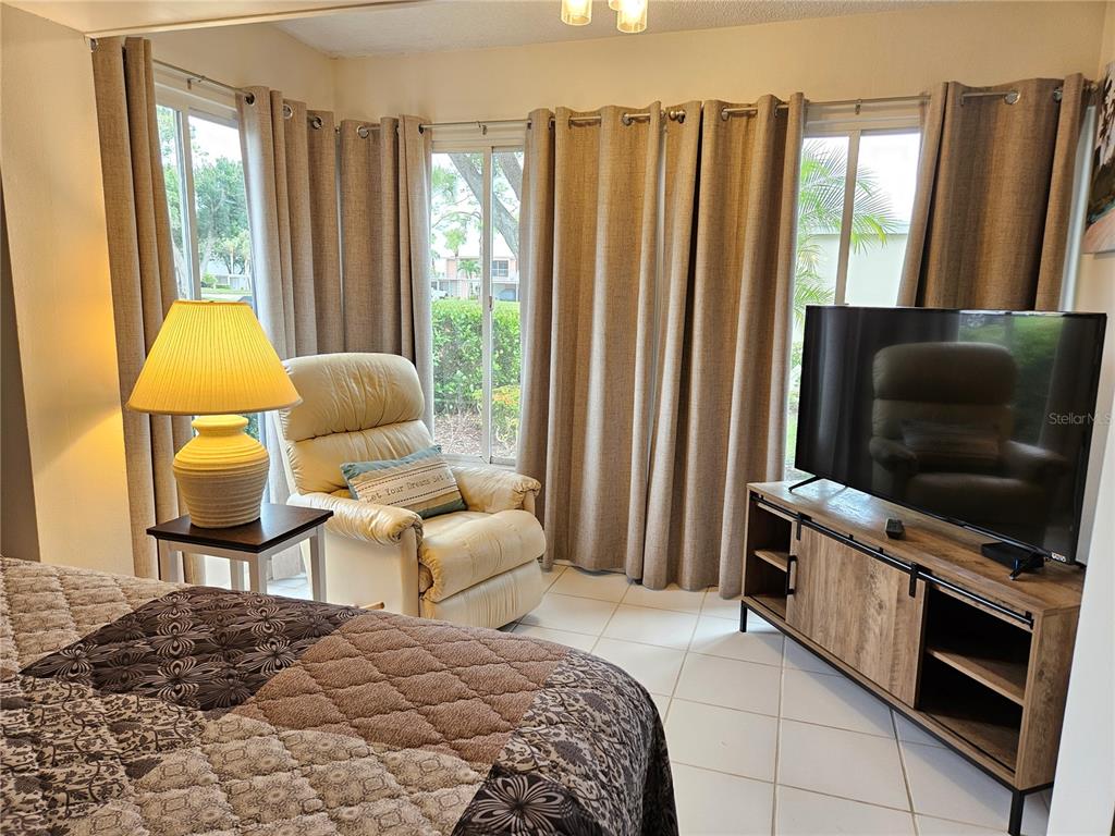 435 Cerromar Lane, Unit 329 Venice, FL 34293 - Photo 44 of 59 a bedroom with a bed and large window
