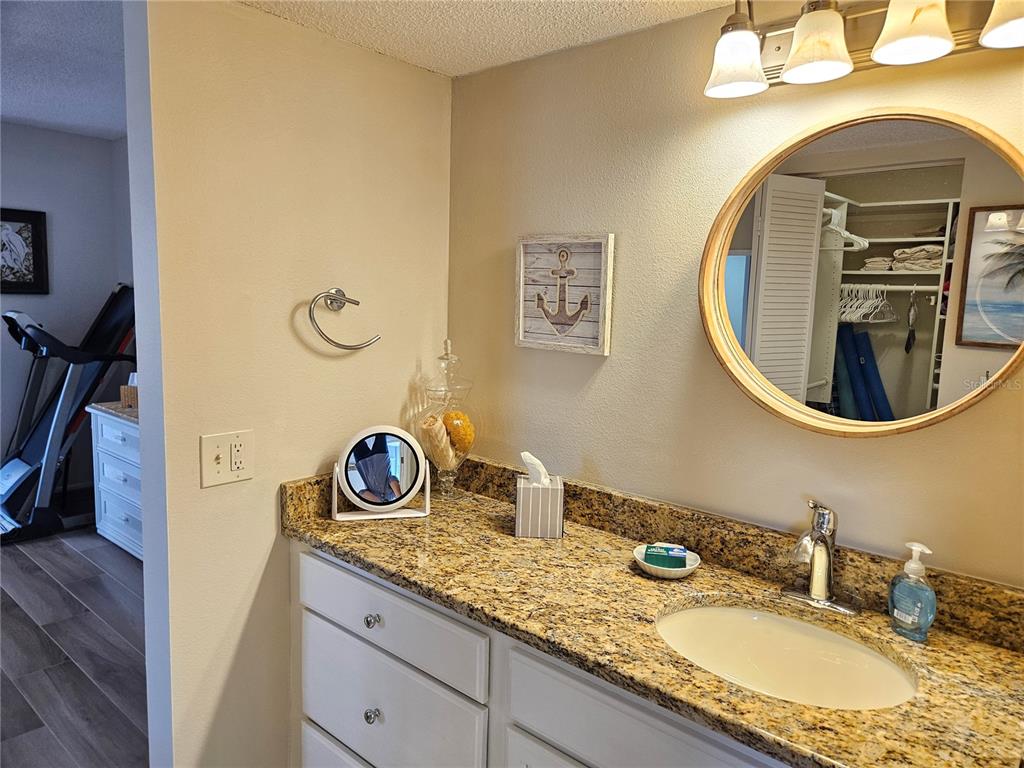 435 Cerromar Lane, Unit 329 Venice, FL 34293 - Photo 50 of 59 a bathroom with a granite countertop double vanity sink and a mirror