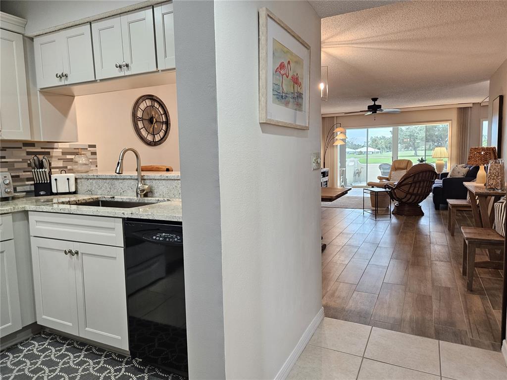 435 Cerromar Lane, Unit 329 Venice, FL 34293 - Photo 5 of 59 a kitchen with a sink and a stove top oven