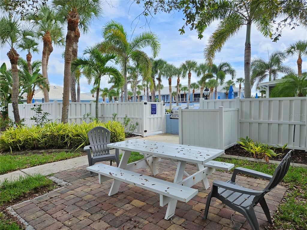 435 Cerromar Lane, Unit 329 Venice, FL 34293 - Photo 58 of 59 a view of a chairs and table in backyard of the house