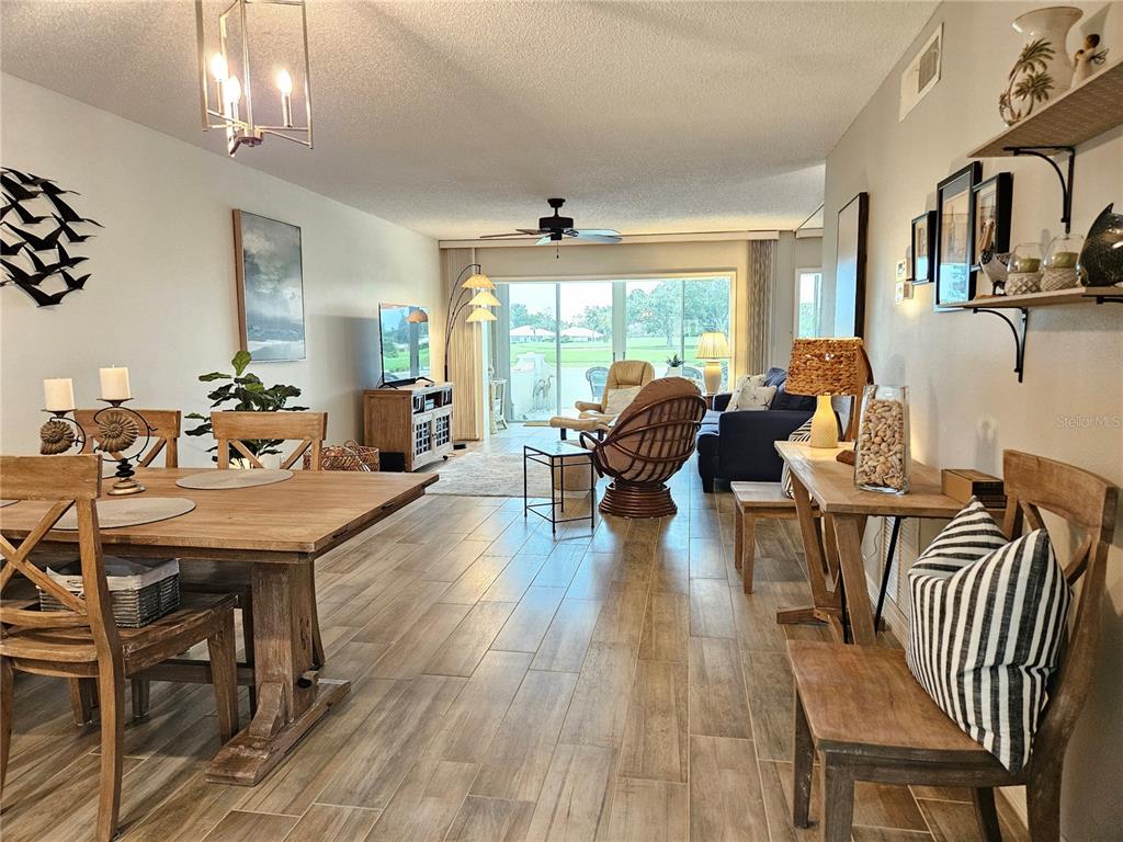 435 Cerromar Lane, Unit 329 Venice, FL 34293 - Photo 6 of 59 a living room with fireplace furniture and a wooden floor