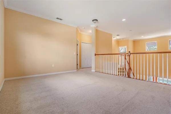 an empty room with windows and closet