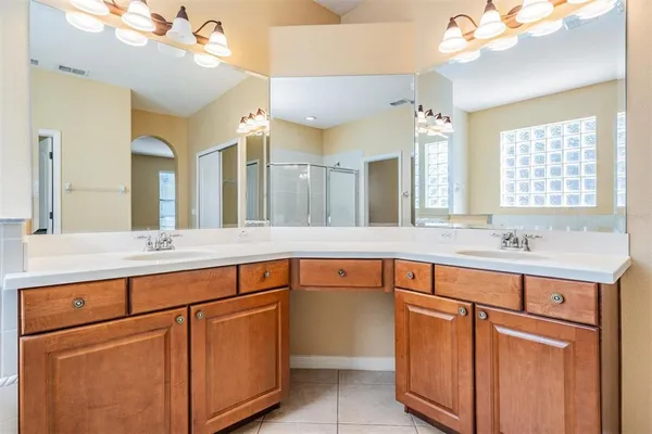 a bathroom with a double vanity sink and a mirror
