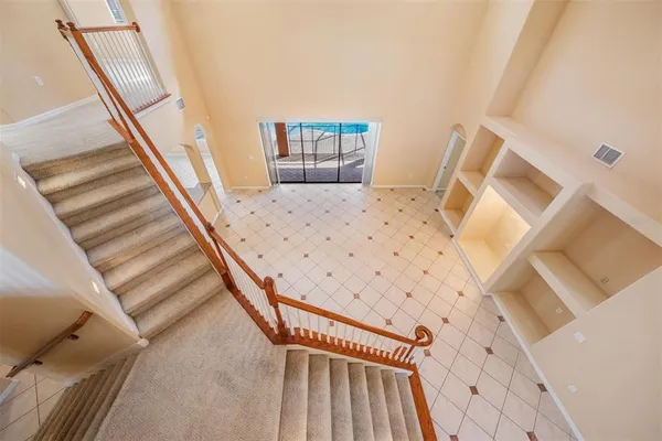 a view of a bedroom with wooden floor and stairs