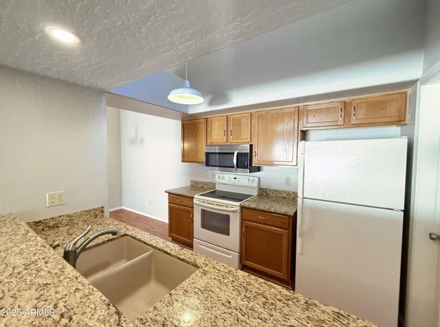 a kitchen with a refrigerator stove and sink