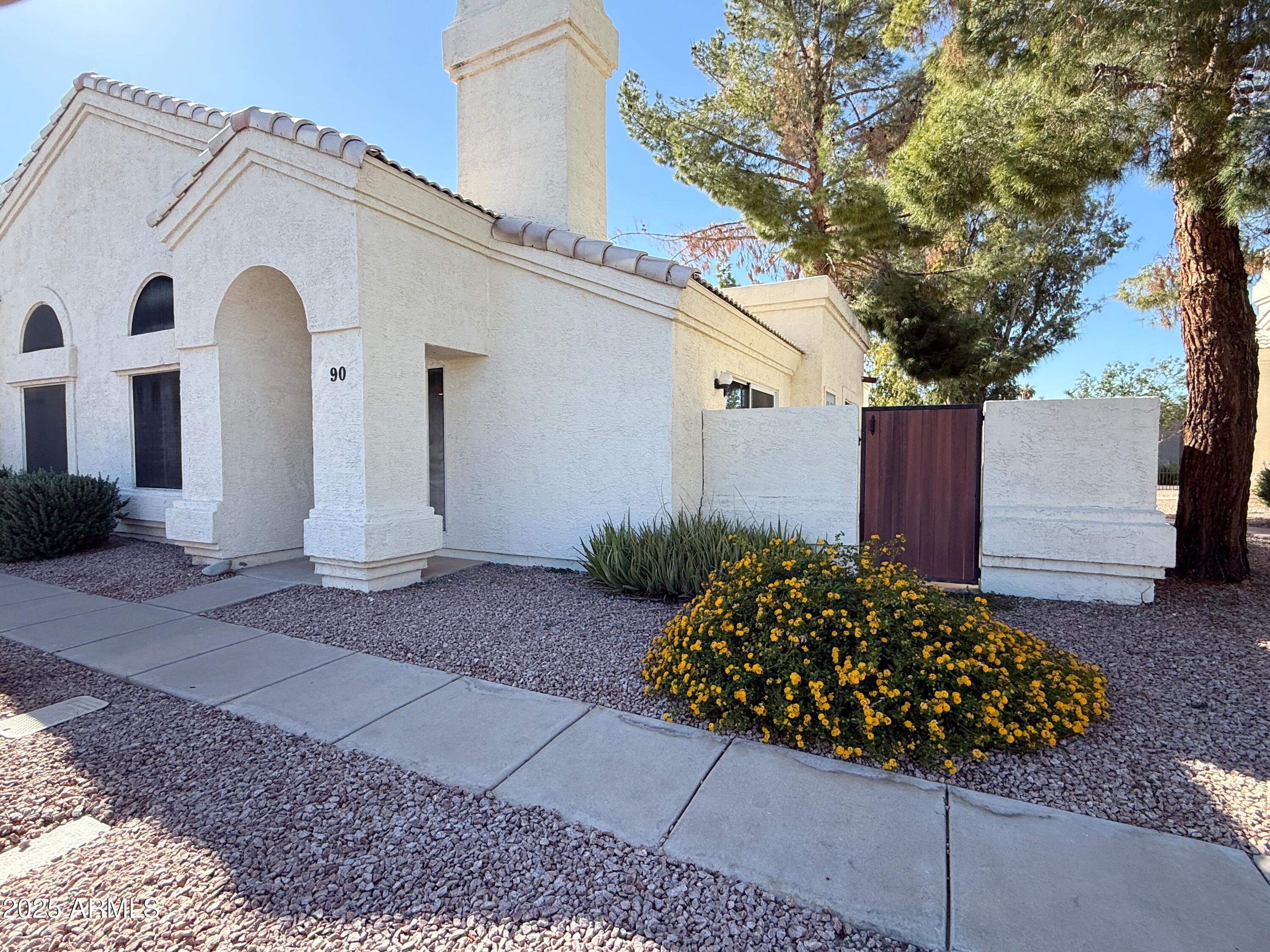 2100 West Lemon Tree Place, Unit 90 Chandler, AZ 85224 - Photo 2 of 24 a view of a back yard of the house