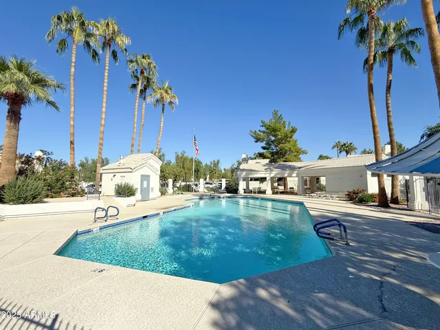 a view of a swimming pool with a yard