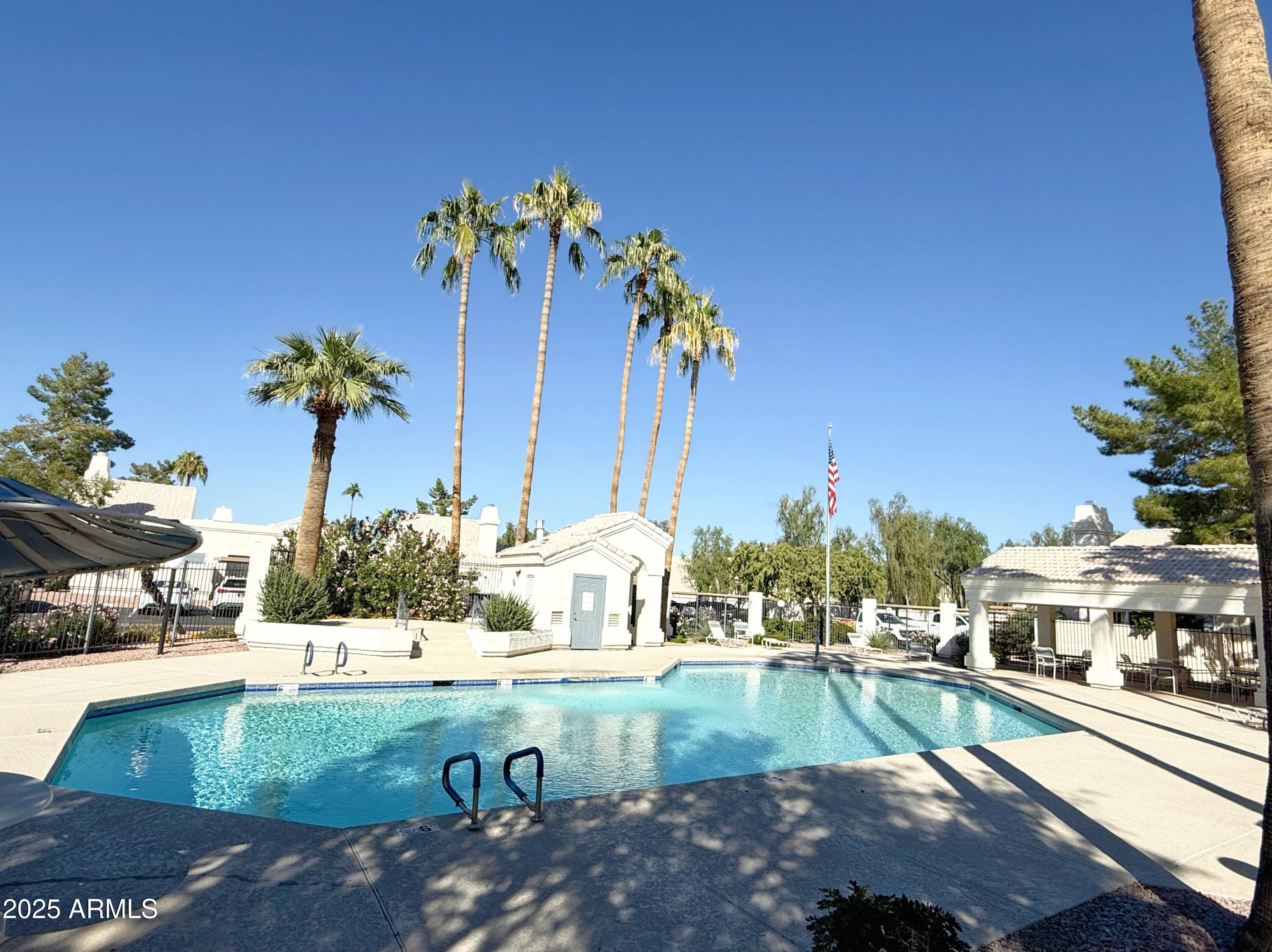 2100 West Lemon Tree Place, Unit 90 Chandler, AZ 85224 - Photo 24 of 24 a view of a swimming pool with a yard