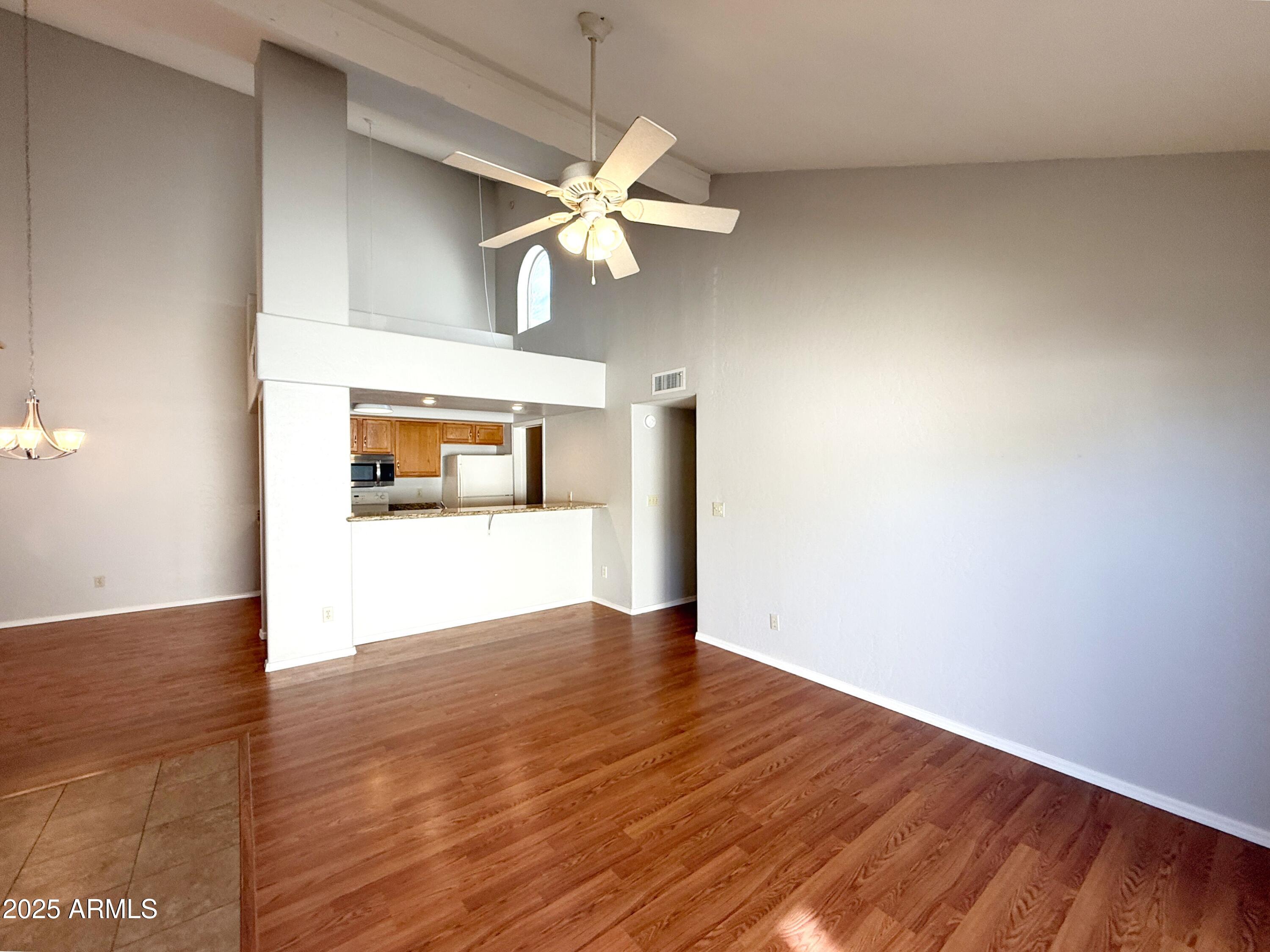 2100 West Lemon Tree Place, Unit 90 Chandler, AZ 85224 - Photo 7 of 24 a view of empty room with wooden floor