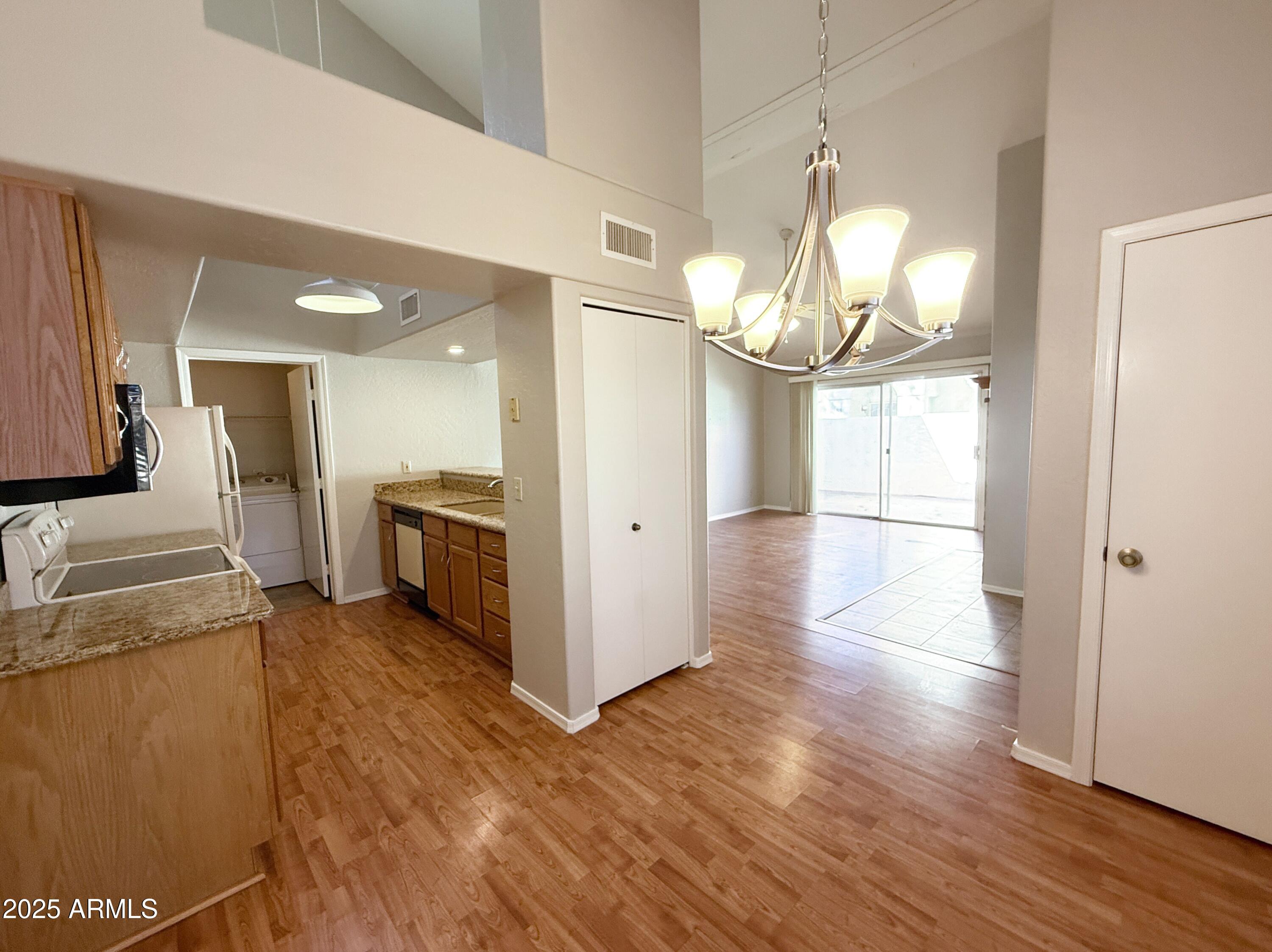 2100 West Lemon Tree Place, Unit 90 Chandler, AZ 85224 - Photo 10 of 24 a view of a kitchen cabinets and wooden floor