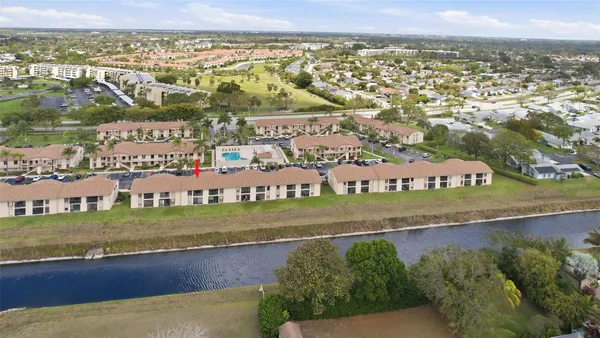 an aerial view of residential houses with outdoor space and swimming pool