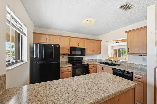 a kitchen with a refrigerator a stove top oven a sink and dishwasher