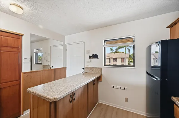 a kitchen with a wooden floor and cabinets